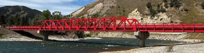 Two Big R Bridges and One Steadfast Carry Vehicles over Snake River